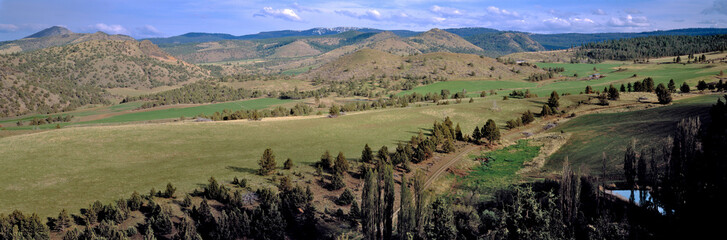 USA, Oregon, Unity. A tidy ranch fills a valley near Unity in eastern Oregon.