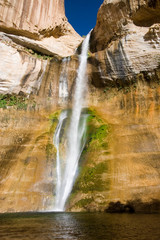 Fototapeta na wymiar USA - Utah. Lower Calf Creek Falls cascades 126 feet into pool in Grand Staircase - Escalante National Monument.