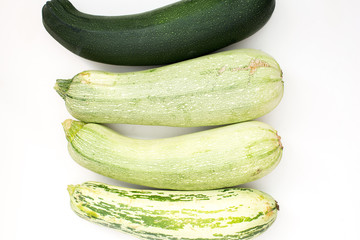Summer harvest of vegetables concept. Zucchini on a light white background.