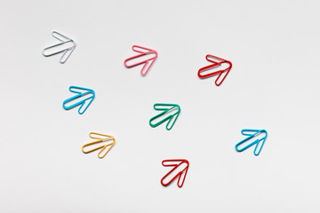 Many arrows pointing upwards on white background, shot from above, closeup.