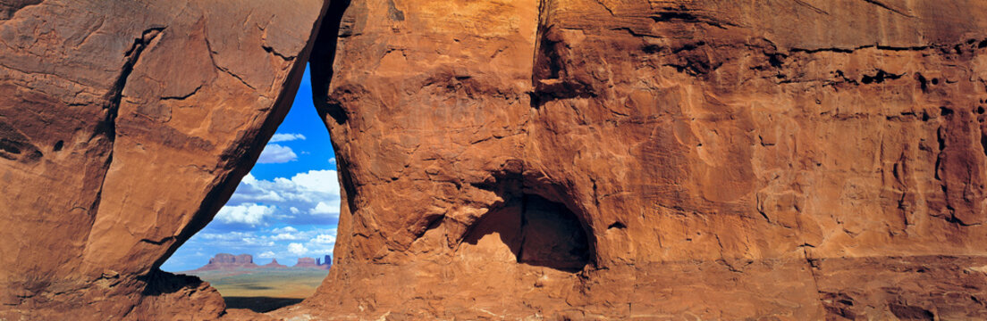 USA, Utah, Monument Valley. A sandstone rock window frames the view to Monument Valley, Utah.