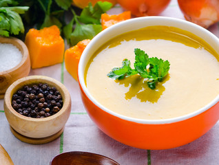 Pumpkin soup served on the table in bowl