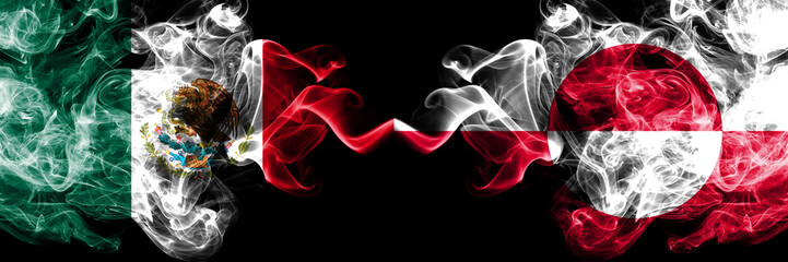 Mexico vs Greenland smoky mystic flags placed side by side. Thick colored silky abstract smokes banner of Mexican and Greenland