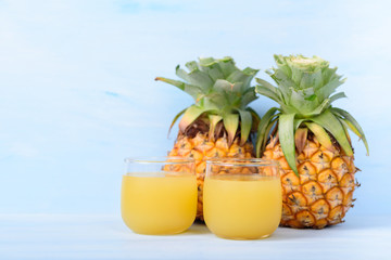 Pineapple juice in glass and ripe pineapple fruit, tropical drink
