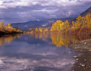 Fototapeta premium WA, Okanogan County, Okanogan River with stormy sky in autumn