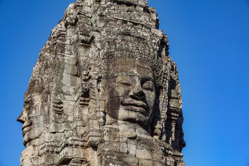 Fototapeta na wymiar Detail Mural faces in the stone of Bayon belong angkor thom nearly angkor wat is popularity of the site among tourists with blue sky in background. UNESCO World Heritage Site. Siem Reap, Cambodia