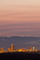 USA, Washington State, Seattle, downtown skyline with Space Needle and Olympic Mountains at sunset.