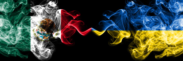 Mexico vs Ukraine, Ukrainian smoky mystic flags placed side by side. Thick colored silky abstract smokes banner of Mexican and Ukraine, Ukrainian
