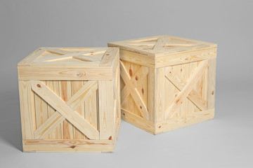 Pair of wooden crates on grey background