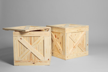 Pair of wooden crates on grey background