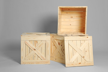 Group of wooden crates on grey background