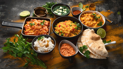 Assorted indian food on black background..