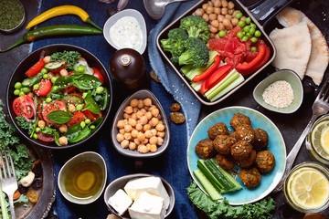 Vegetarian variety dishes on black background.