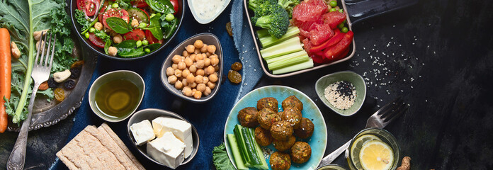 Vegetarian variety dishes on black background.