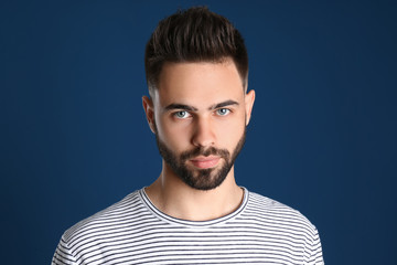 Obraz premium Portrait of handsome young man on color background