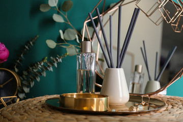 Fototapeta na wymiar Composition with stylish accessories and interior elements on table near turquoise wall