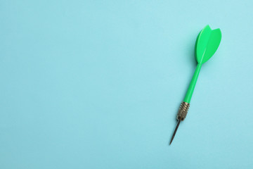 Green dart arrow on blue background, top view with space for text