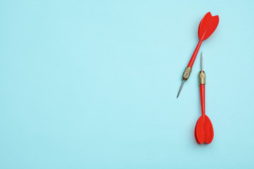 Red dart arrows on blue background, flat lay with space for text