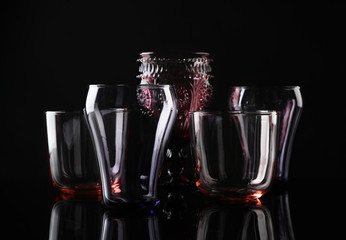 Set of different colorful empty glasses on black background