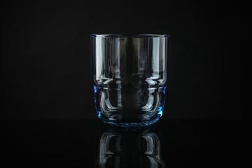Elegant empty colorful whiskey glass on black background