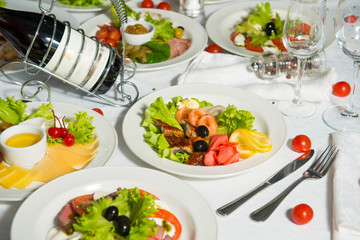 Restaurant dish of fish with olives and lemon on a table in a plate.Cold appetizer.