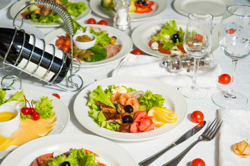 Restaurant dish of fish with olives and lemon on a table in a plate.Cold appetizer.