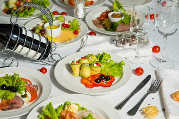 A restaurant dish of stuffed zucchini and sweet pepper on a table in a plate. Cold appetizer.