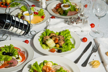 A restaurant dish of stuffed eggplant and olives on a table in a plate. Cold appetizer.