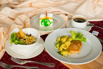 Three-course business lunch on a beige tablecloth in a restaurant.