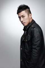 Korean male in his 30s wearing a leather jacket.