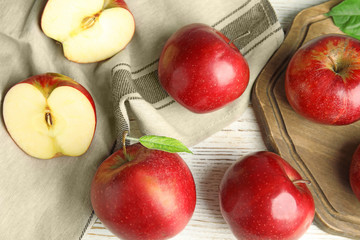 Naklejka na ściany i meble Ripe juicy red apples on white wooden background, flat lay