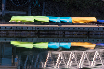 USA, Washington State. Kayaks reflection, calm marina.