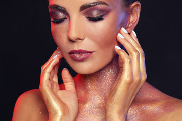 Sexy young woman with glitter makeup on black background, closeup