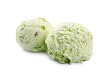 Scoops of delicious pistachio ice cream on white background