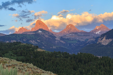 Fototapeta premium USA, Wyoming. Teton Range glows at sunset as viewed from the west.