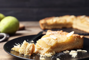 Piece of delicious sweet pear tart on table, closeup