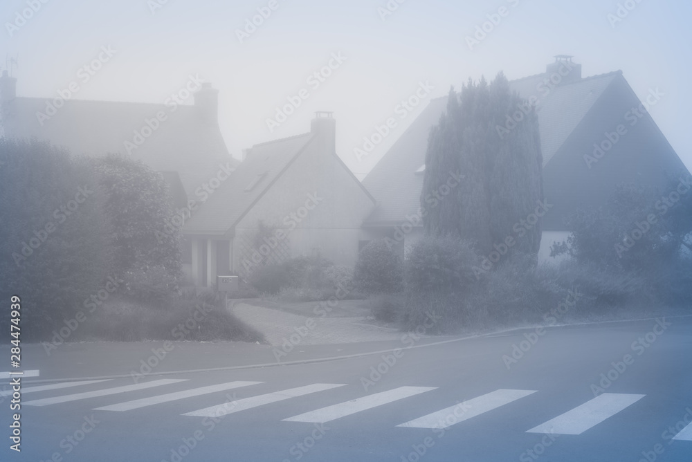 Wall mural heavy fog in the town of perros-guirec. vintage style. brittany. france