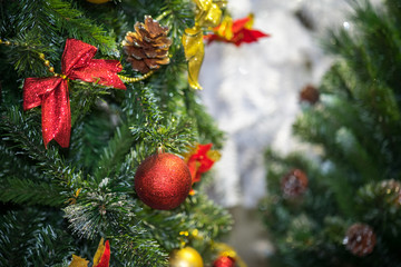 Decorations on christmas tree at night with bokeh on background, soft focus