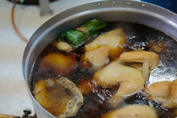 chicken boiling in fish sauce soup. boiled chicken