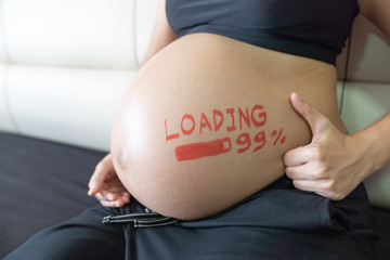Pregnant woman touching on her big belly.