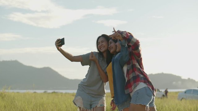 Group of a young Asian woman taking selfies having fun together a summer traveling. Lifestyle travel holiday vacation time. Having a mountain background.