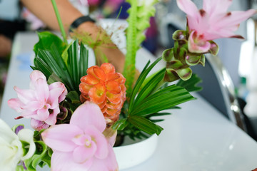 florist arranging flower bouquet in vase. floristry class course workshop