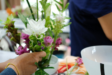 Obraz na płótnie Canvas florist arranging flower bouquet in vase. floristry class course workshop
