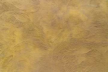 Background of Old yellow color cement wall detail.