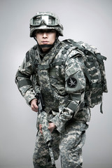 Armed soldier holding a rifle.