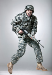 Armed soldier holding a rifle.