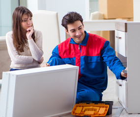 Contractor repairman assembling furniture under woman supervisio