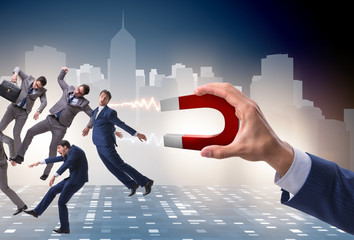 Businessman in recruitment concept with horseshoe magnet