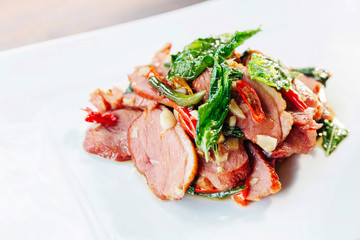 Top view of close-up Wagyu beef stir-fried with basil, garlic and chili. Japanese ingredients in Thai food. Asian Fusion Food.