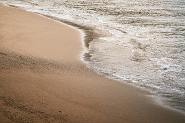 brown sand with sunrise and seascape wave with bubble